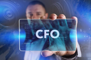 Business Technology Internet and network concept. Young businessman working on a virtual screen of the future and sees the inscription: CFO